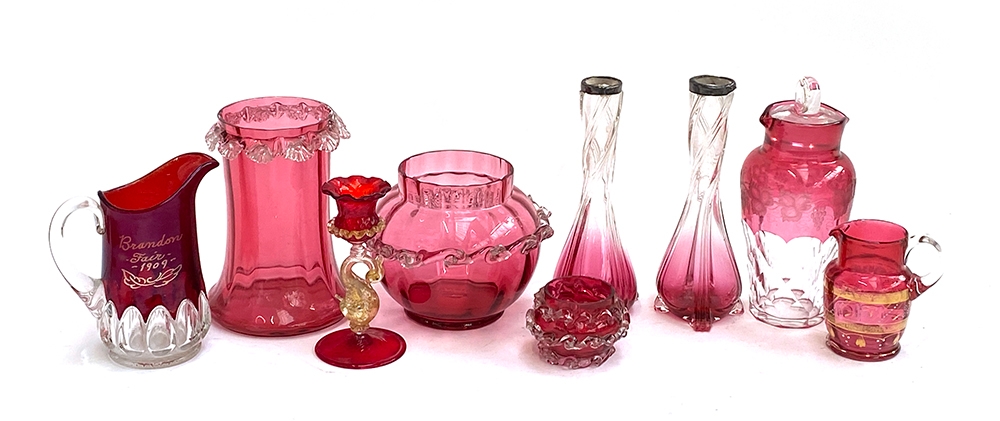 A collection of cranberry glass to include a pair of vases with silver collars; Brandon Fair 1909