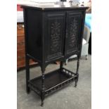 An ebonised Aesthetic movement side cabinet, two doors with carved floral urn motif, undershelf with