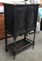 An ebonised Aesthetic movement side cabinet, two doors with carved floral urn motif, undershelf with