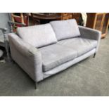 A contemporary grey two seater sofa on chromed steel frame, 168cm wide 90cm deep