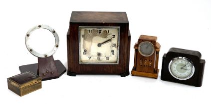 An Art Deco style mantel clock; a smaller bakelite mantel clock; a small oak and marquetry mantel