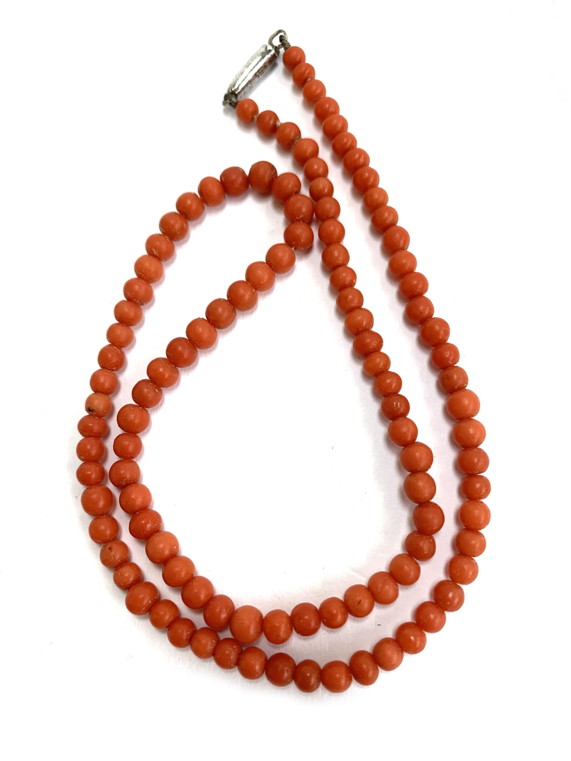 An early 20th century red coral bead necklace, the beads subtly graduating from 3.5mm to 4.5mm, - Image 2 of 2