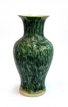 A large green glazed pottery vase, 52cmH