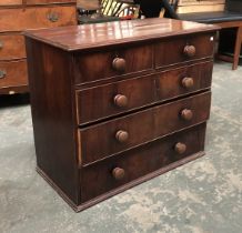 A 19th century mahogany chest of two short over three graduating drawers (feet missing), turned