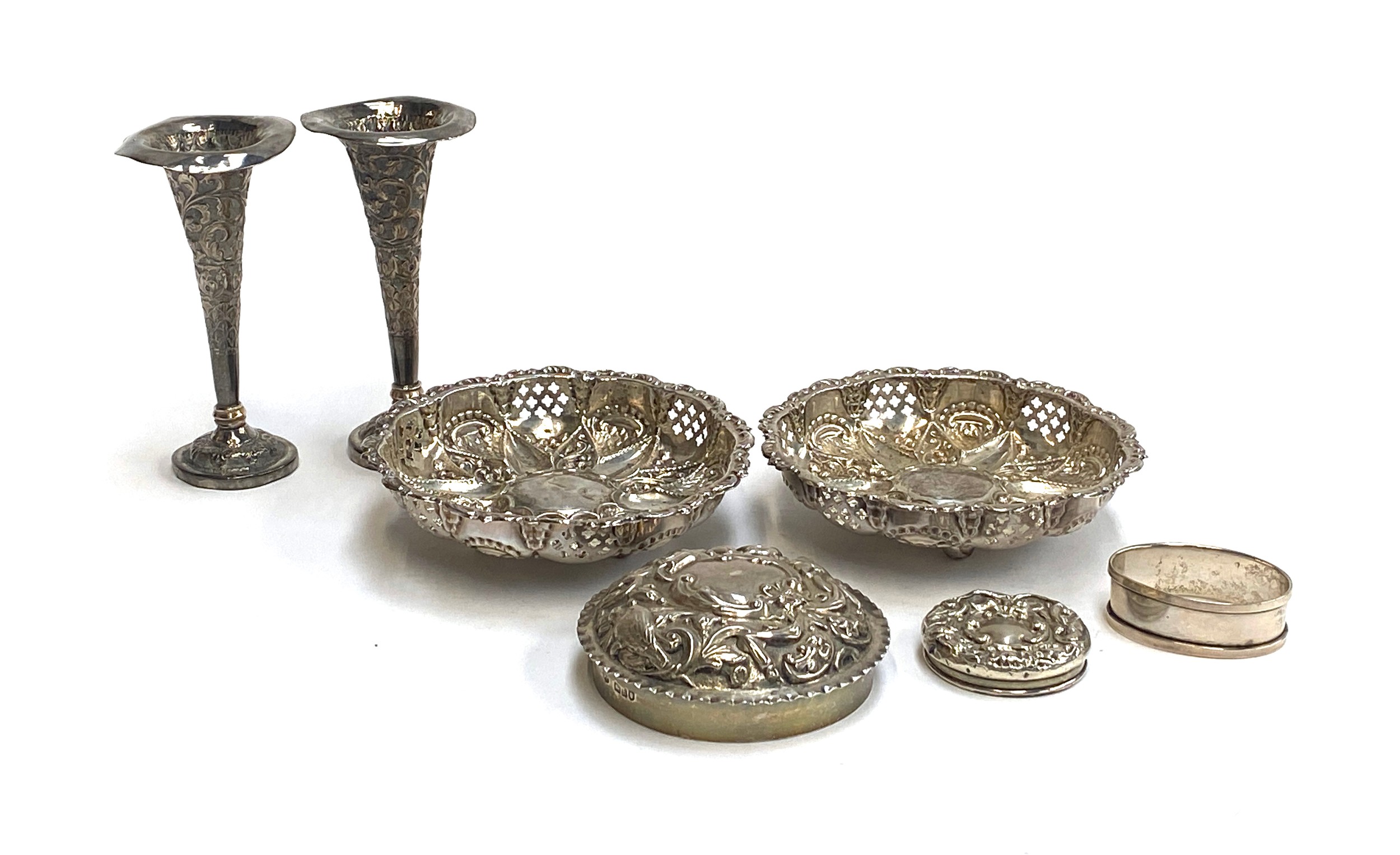 A pair of hallmarked silver chased and pierced bonbon dishes; two chased silver lids; silver