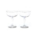 A pair of hand blown champagne cups with cut faceted stems, together with a further set of six cut