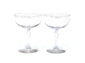 A pair of hand blown champagne cups with cut faceted stems, together with a further set of six cut