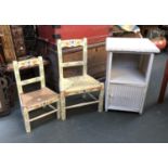 A white painted Lloyd Loom style bedside cabinet, 64cmH; together with two painted child's chairs