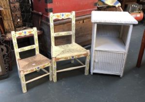 A white painted Lloyd Loom style bedside cabinet, 64cmH; together with two painted child's chairs