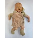 An early 20th century Hugo Weigand doll with porcelain head and hands, stamped Germany HW