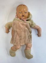 An early 20th century Hugo Weigand doll with porcelain head and hands, stamped Germany HW