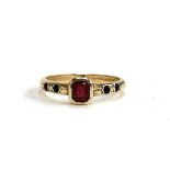 A 9ct gold ring set with an emerald cut garnet, size N, 2.3g