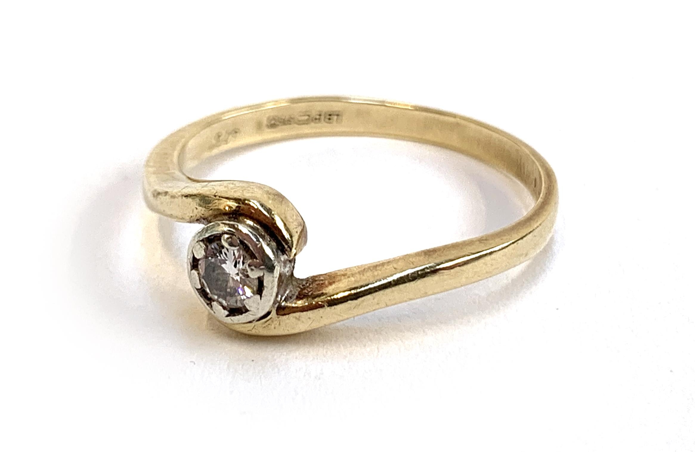 A 9ct gold ring with a crossover set diamond, the diamond 3.8mm diameter, size P 1/2, 2.6g - Image 2 of 2