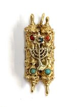 A gold Torah charm with minora detail set with a sapphire, tests as 14ct, 8g