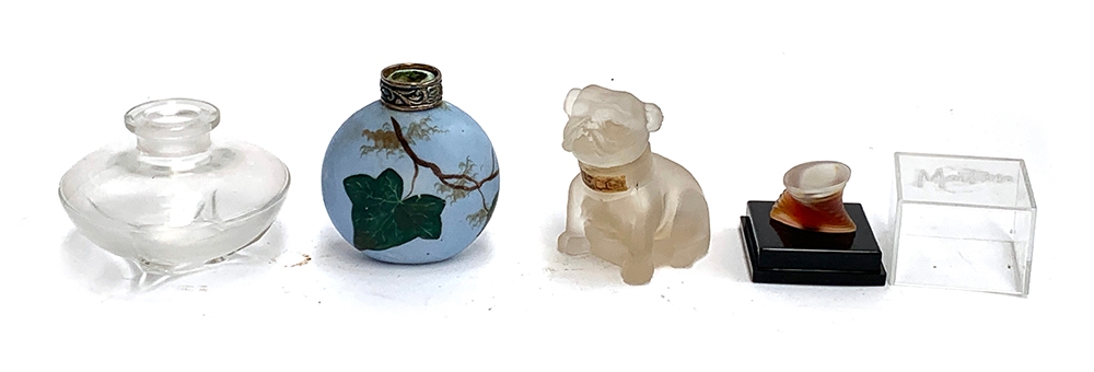 A frosted glass perfume bottle in the form of a bulldog; together with others including one hand