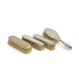 A pair of early 20th century silver backed clothes brushes and hair brush by Finnigans; together