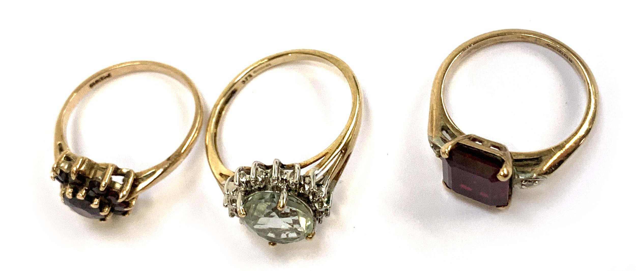 Three 9ct gold rings: one set with garnets size M, one synthetic ruby size L, the other green - Image 2 of 2