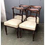 A set of four 19th century mahogany dining chairs, curved rail with stuffover seats, on turned
