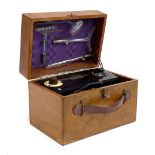 A Violet Ray Vitalator no. 3922, bakelite with four glass attachments, in a wooden case, 26cmW