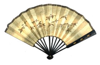 A hand painted Japanese fan, one side depicting sparrows in flight, the other an eagle in a tree,