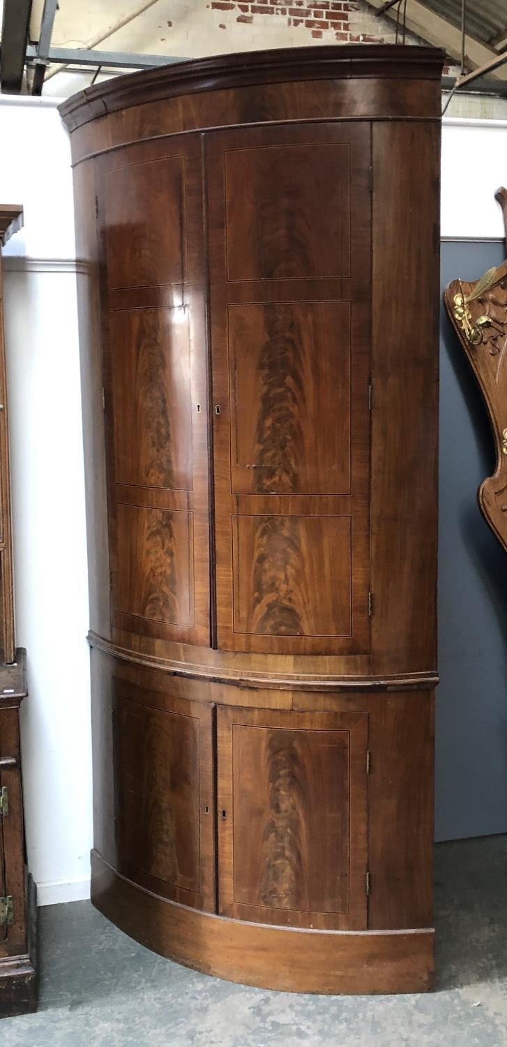 A massive George III bowfront standing corner cupboard, 240cmH