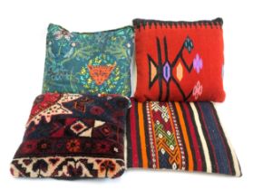 Four cushions to include two kilim covered and one carpet covered