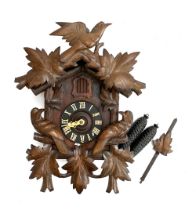A carved cuckoo clock, with weights