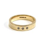 A 9ct gold band gypsy set with three small diamonds, size M, 3.4g