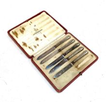 A set of five silver handled butter knives, cased