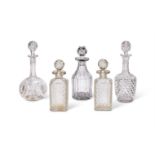 Five cut glass decanters with stoppers, late 19th and 20th century, including a pair of spirit