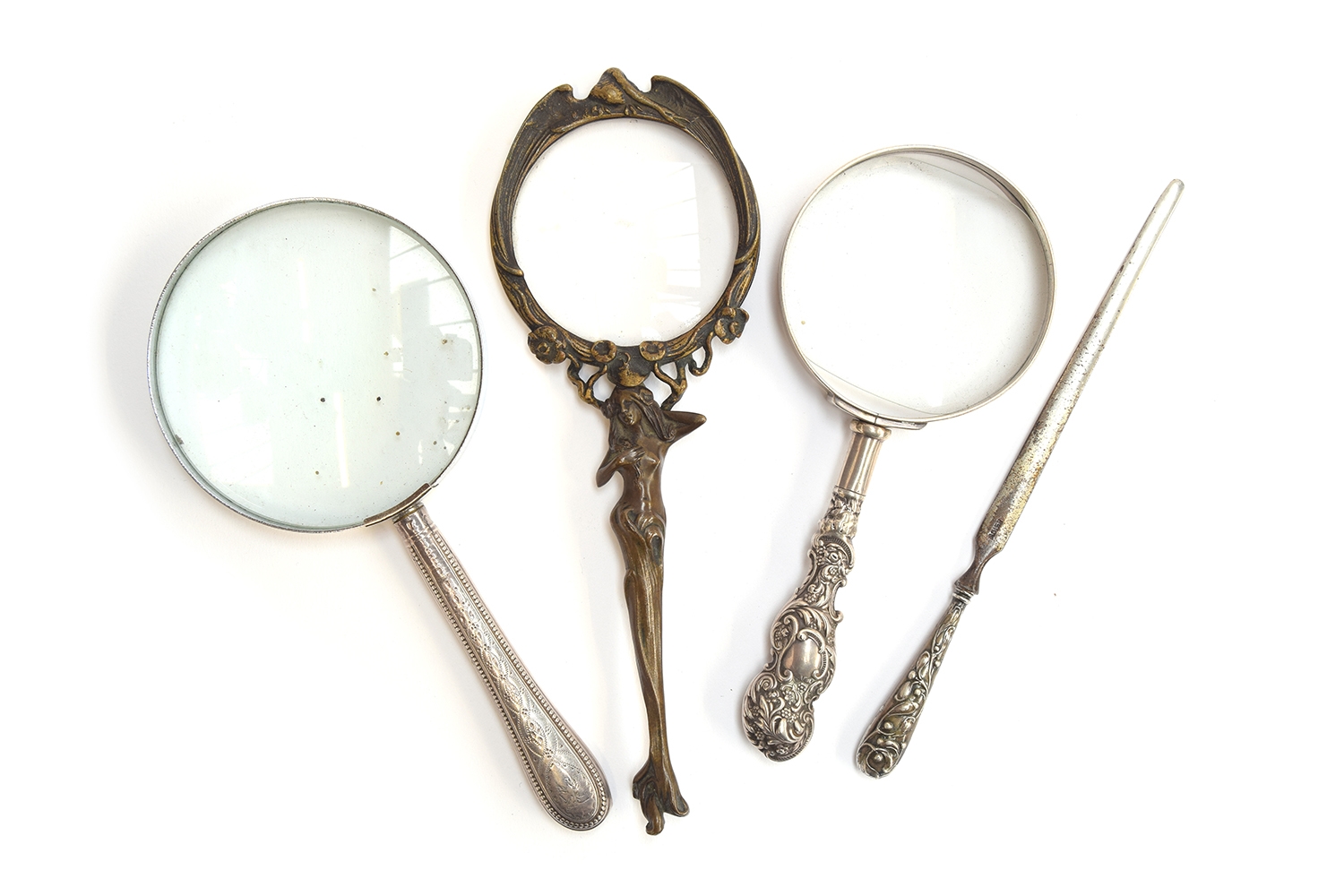 A bronze Art Nouveau style magnifying glass, the handle in the form of a semi clad lady, 20.5cm