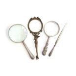 A bronze Art Nouveau style magnifying glass, the handle in the form of a semi clad lady, 20.5cm