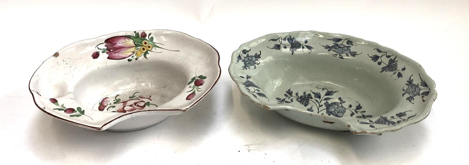Two ceramic shaving dishes, both with floral designs, with staple repairs, 30cmW & 33cmW (af)