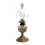 A late Victorian Hinks & Sons brass Duplex oil Lamp, floral design to base, the glass shade etched