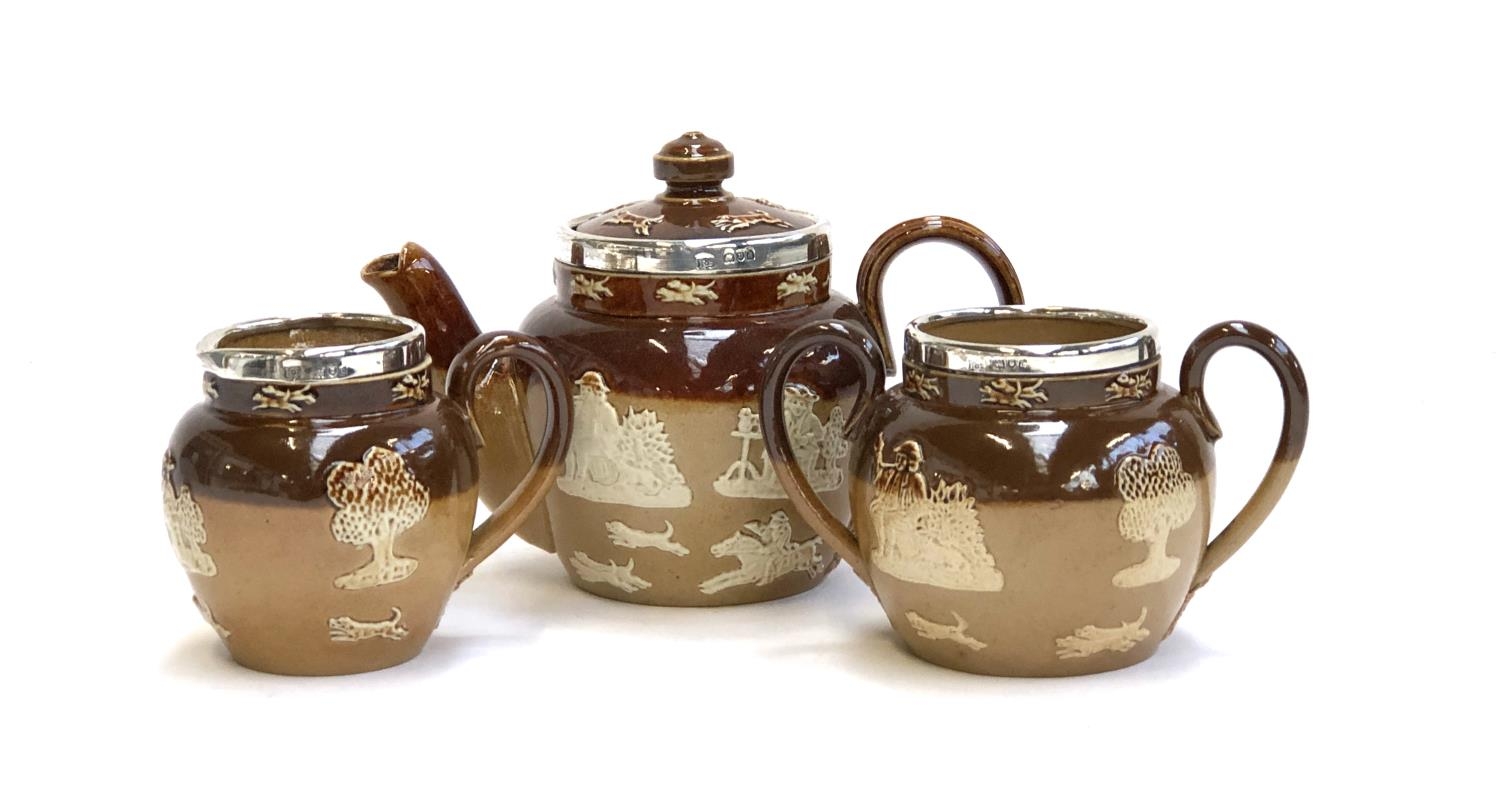 A miniature Royal Doulton Lambeth Stoneware tea set, comprising teapot, 10.5cmH, milk jug, and sugar