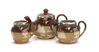 A miniature Royal Doulton Lambeth Stoneware tea set, comprising teapot, 10.5cmH, milk jug, and sugar