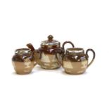 A miniature Royal Doulton Lambeth Stoneware tea set, comprising teapot, 10.5cmH, milk jug, and sugar