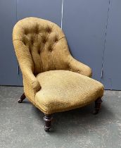 A 19th century button back slipper chair, yellow upholstered, with turned front legs and casters,