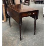 A Regency mahogany Pembroke table with single drawer, on tapering ring turned legs and brass