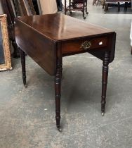 A Regency mahogany Pembroke table with single drawer, on tapering ring turned legs and brass