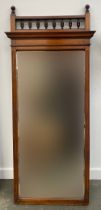 A late 19th early 20th century mahogany mirror with bevelled glass and turned spindles above,