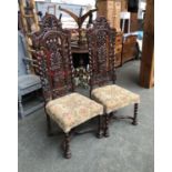 A pair of 19th century oak hall chairs, in Jacobethan taste, the carved backs with barleytwist