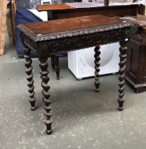 A carved oak side table, in the Jacobethan taste, with single drawer and barleytwist supports,