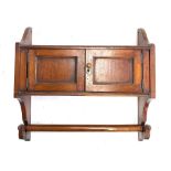 A 19th century mahogany wall shelf, two cupboards with towel rail below, 48.5cmW