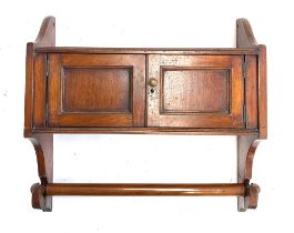 A 19th century mahogany wall shelf, two cupboards with towel rail below, 48.5cmW