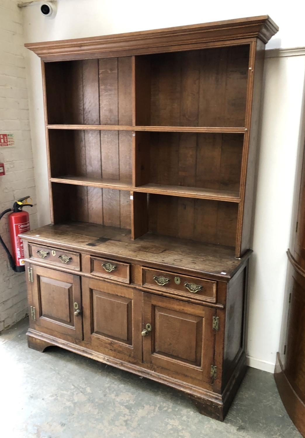 An oak dresser, the base with three drawers over panelled cupboards, 148x50x209cmH