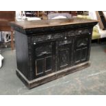 A carved oak sideboard, two drawers over central drawer and cupboard, flanked by two further