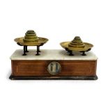 A set of early 20th century marble topped and mahogany apothecary scales, with brass weights, 35.