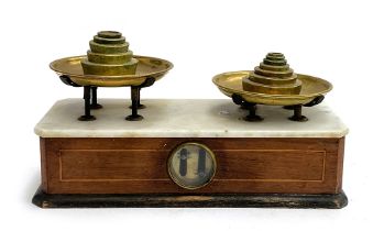 A set of early 20th century marble topped and mahogany apothecary scales, with brass weights, 35.