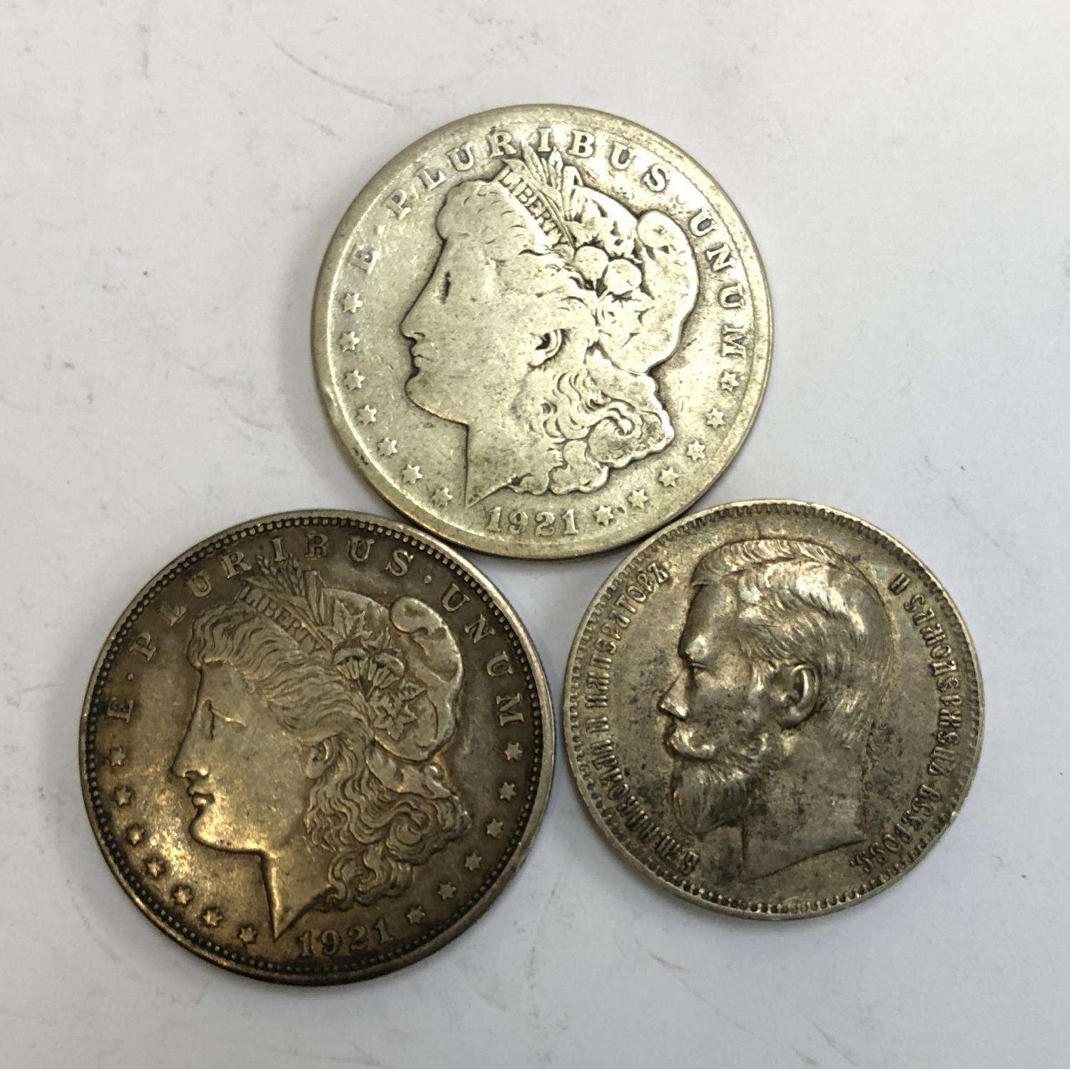 Two United States of America one dollar coins, 1921, together with 1 Rouble, Russia, 1898